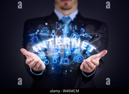 Internet concept, businessman holding internet word and social media illustration Stock Photo