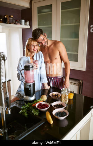 Happy male and female in kitchen having breakfast Stock Photo