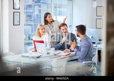 Group of businesspeople presenting ideas to clients at his office Stock Photo