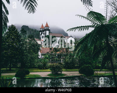 View towards Church of Furnas in Terra Nostra Garden Park on Sao Miguel island, Furnas, Azores. It is located in the midst of this magnificent water Stock Photo