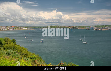 A view across Milford Haven to Neyland, the Cleddau Bridge and Pembroke Dock on a summer day with clouds Stock Photo