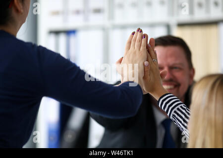 Happy workers in office celebrating new corporate achievement Stock Photo