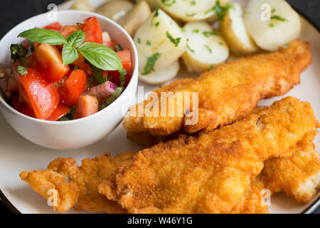 Fillets of Pouting, Trisopterus luscus, that have been dipped in flour, egg and breadcrumbs and deep fried. The pouting, also known as bib, whiting po Stock Photo