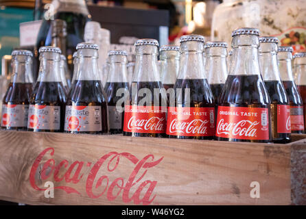 Rotterdam Netherlands, June 27, 2019. Coca cola glass bottles in a wooden box, Rotterdam markthal, closeup view Stock Photo