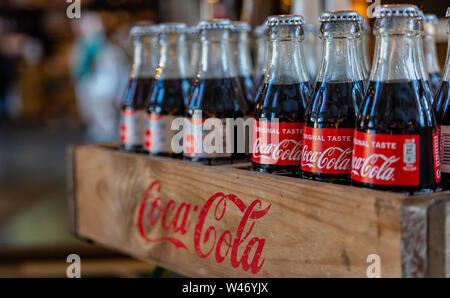 Rotterdam Netherlands, June 27, 2019. Coca cola glass bottles in a wooden box, Rotterdam markthal, closeup view Stock Photo