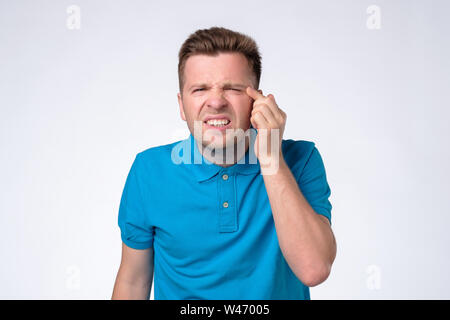 man with narrow eyes squinting trying to see small text Stock Photo