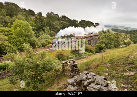 Stainforth, North Yorkshire, UK. 20th July 2019. Steam locomotive 60163  'Tornado' hauls the 'North Briton' steam special up the gradient of the Settle-Carlisle railway line towards Carlisle. Seen here at Stainforth in the Yorkshire Dales National Park, crossing Sheriff's Brow Viaduct. The excursion began and finished in London, with steam haulage over the Doncaster-Carlisle-Newcastle section of the route. The beginning and end parts of the trip were hauled by a mainline electric class 86 locomotive.