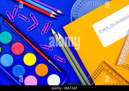 Back To School Note Book and Pencils With A Paint Box Paper Clips and Geometry Set Stock Photo