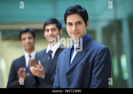 Portrait of a businessman with his colleagues in the background Stock Photo