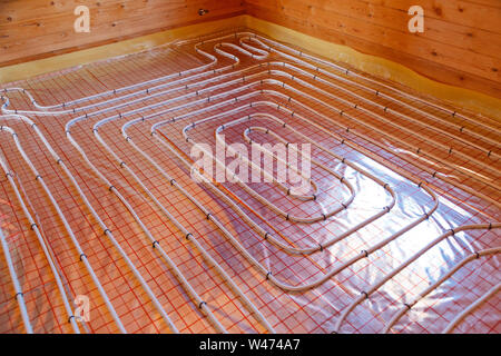Underfloor surface heating pipes. Low temperature heating concept. Stock Photo