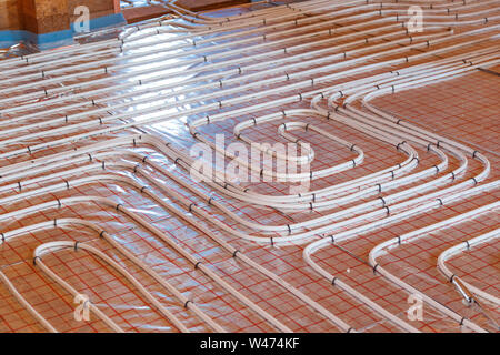 Underfloor surface heating pipes. Low temperature heating concept. Stock Photo