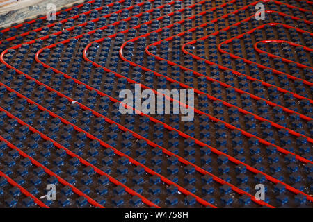 Underfloor heating installation. Close up on water floor heating system interior. plumbing pipes. Individual Heating Stock Photo