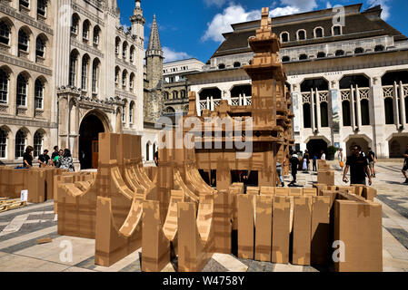 Guildhall Yard, London, UK. 20th July 2019. Volunteers helping to build the 20m cardboard People's Tower by artist Olivier Grossetête in Guildhall yard. Built on Saturday the tower will be knocked over on Sunday. Credit: Matthew Chattle/Alamy Live News Stock Photo
