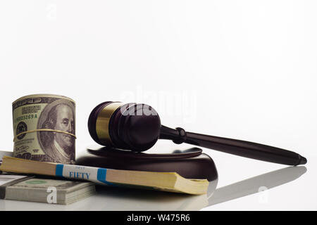 Judge's gavel and packs of dollars and euro banknotes on a white background. The concept of growing national debt- image Stock Photo