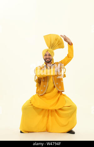 Man performing bhangra dance Stock Photo