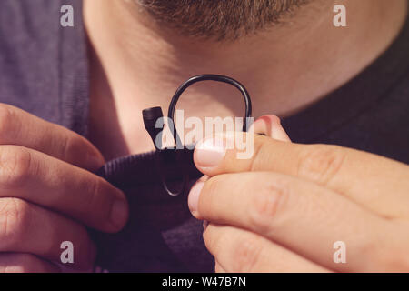 A man clipping tie-clip microphone Stock Photo