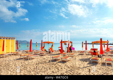 Small beach with colorful umbrellas in resort city San Remo. Liguria, Italy Stock Photo