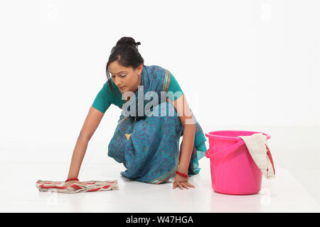 Woman wiping floor Stock Photo