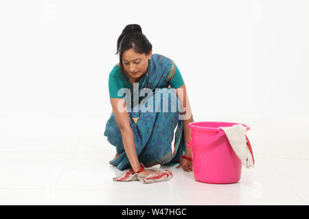 Woman wiping floor Stock Photo