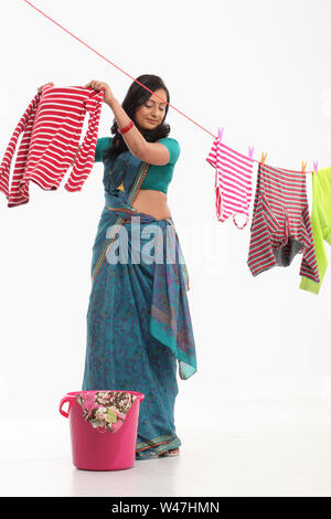 Woman drying clothes on washing line Stock Photo