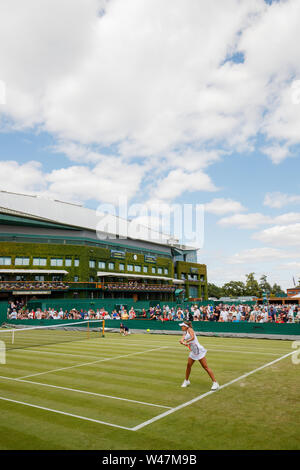 General View of Anna Karolina Schmiedlova and Monica Puig on Court 4 with Centre Court behind at The Wimbledon Championships 2019. Held at The All Eng Stock Photo