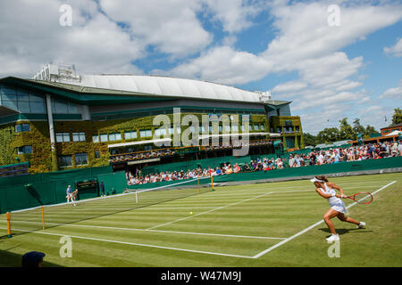 General View of Anna Karolina Schmiedlova and Monica Puig on Court 4 with Centre Court behind at The Wimbledon Championships 2019. Held at The All Eng Stock Photo