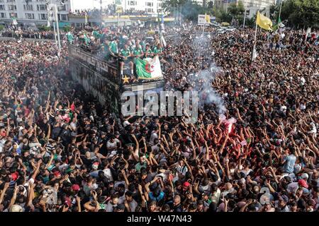 Algiers, Algeria. 20th July, 2019. Algerian national soccer team players celebrate with thousands of supporters after having clinched the 2019 Africa Cup of Nations soccer trophy in Egypt. Credit: Farouk Batiche/dpa/Alamy Live News Stock Photo