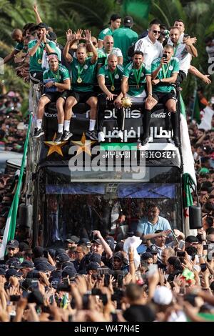 Algiers, Algeria. 20th July, 2019. Algerian national soccer team players celebrate with thousands of supporters after having clinched the 2019 Africa Cup of Nations soccer trophy in Egypt. Credit: Farouk Batiche/dpa/Alamy Live News Stock Photo