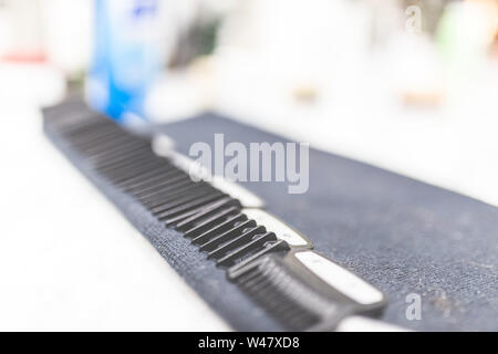Close up of plastic hair clipper combs on desk at barbershop. Stock Photo