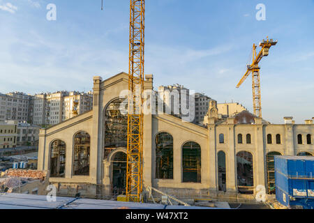MOSCOW, RUSSIA, 01 MAY, 2019: Yellow construction crane tower against a blue sky on a building site Stock Photo