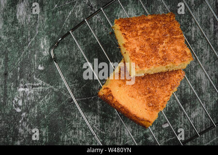 Yellow Corn Bread Squares Slices on Dark Rustic Background Stock Photo