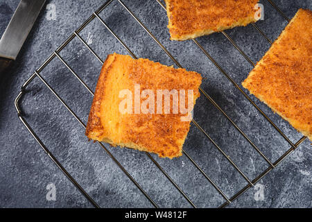 Yellow Corn Bread Squares Slices on Dark Rustic Background Stock Photo