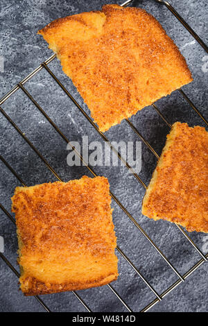 Yellow Corn Bread Squares Slices on Dark Rustic Background Stock Photo