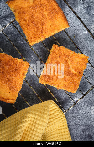Yellow Corn Bread Squares Slices on Dark Rustic Background Stock Photo