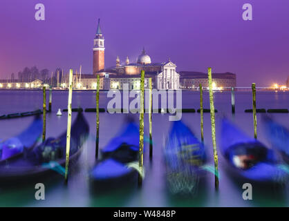 Venice, Italy. Gondolas moored at Piazza San Marco at sunset with the church of San Giorgio Maggiore Stock Photo