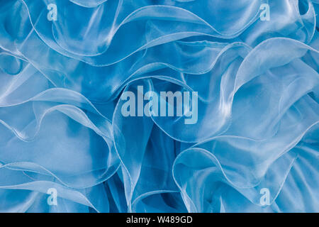 Close up abstraction of blue-green Quinceanera dress in a shop window in Downtown Los Angeles, California. Stock Photo