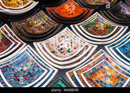 Colorful mosaic decorative plates on the market for sale on local street market in Ubud, island Bali, Indonesia, close up . Souvenirs for tourist Stock Photo