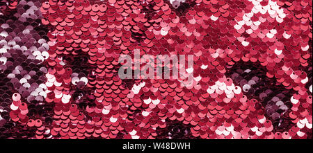 Shining Coral sequins on fabric. Festive duotone background. Stock Photo