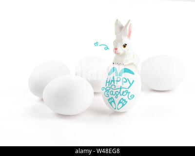 Happy Easter lettering on egg and wood rabbit on white background, Easter design with cute bunny and text, hand drawn illustration Stock Photo