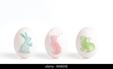 rabbit painted with watercolor on a white egg, easter eggs isolated on a white background,  easter design with cute bunny, hand drawn illustration Stock Photo
