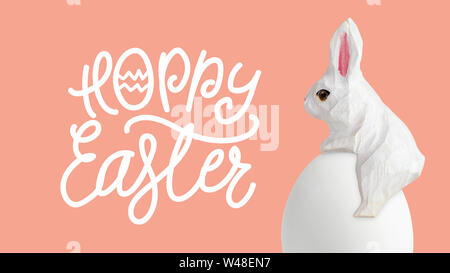 Happy Easter lettering with egg and wood rabbit on orrange background, Easter design with cute bunny and text, hand drawn illustration Stock Photo