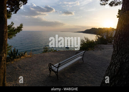 seat bench in the sunset with a view of the sea
