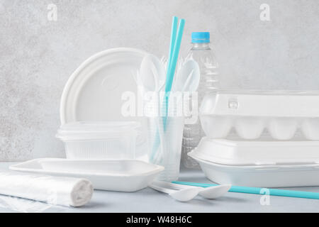 Set of white plastic disposable tableware and packaging. Various crockery. Environmental pollution concept. Stock Photo