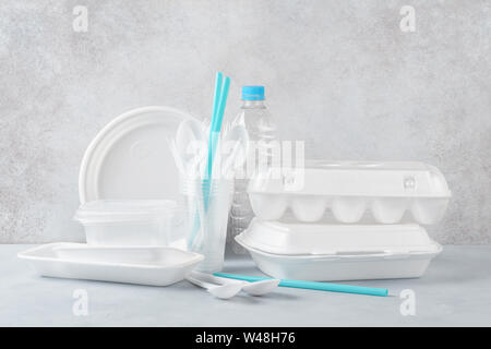 Set of white plastic disposable tableware and packaging. Various crockery. Copy space. Stock Photo