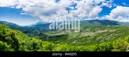 Montenegro, XXL panorama view of green valley bjelopavlici plain lowlands from mountains near ostrog monastery with blue sky and thunderstorm clouds Stock Photo