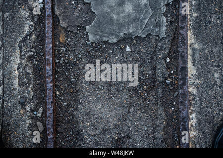 Dark concrete texture with old rail road line background graphic asset. Stock Photo