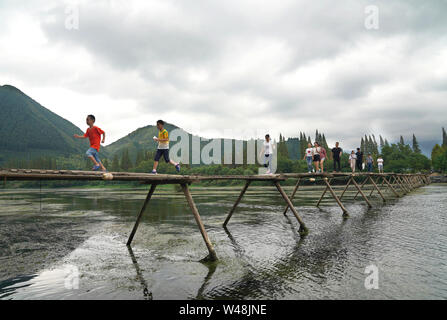 (190721) -- BEIJING, July 21, 2019 (Xinhua) -- Tourists enjoy themselves in Xiayu Village of Yinkeng Township in Kaihua County, one 'natural oxygen bar,' east China's Zhejiang Province, Aug. 25, 2018. As more and more Chinese people are choosing to visit places that have fresh air, thick forests and are rich in negative ions, ecotourism becomes a fresh favoured choice across the country.    According to a report by the China Meteorological Service Association, trips to the regions granted as 'natural oxygen bars' by the association surged over 200 percent year on year in 2018. (Xinhua/Song Zhe Stock Photo