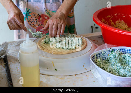 Preparing stuffed pita with labaneh and hyssop Stock Photo