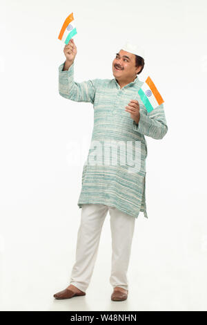 Indian politician standing with Indian Flags Stock Photo