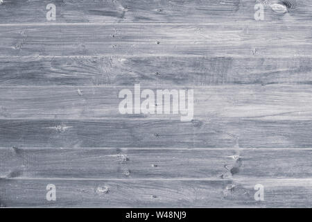 Gray wooden background. Grey wood boards, messy fence, planks. Weathered, vintage surface, pattern. Horizontal stripes on shabby parquet. Dirty light Stock Photo
